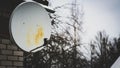 satellite dish hanging on a brick wall Royalty Free Stock Photo