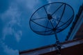 Satellite dish on house roof at night time Royalty Free Stock Photo