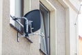 Satellite dish installed in the window area of a house