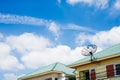 Satellite dish on the roof with a blue sky background. Royalty Free Stock Photo