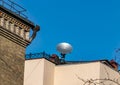 Satellite dish on the roof of the building against the blue sky Royalty Free Stock Photo