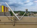 A satellite dish on the roof of an old house in the village