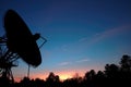 satellite dish silhouette against twilight sky Royalty Free Stock Photo