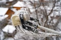 Satellite dish in snow. Satellite dish frozen hanging on front cottage wall in a snowy winter outdoors