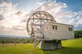 Satellite dish in a summer landscape, radiotelescope for deep space research. Ondrejov observatory, Czech republic. Royalty Free Stock Photo