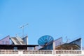 Satellite dish and television antenna on the old building with the blue sky background Royalty Free Stock Photo