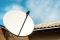 Satellite dish on wall of a country house Royalty Free Stock Photo