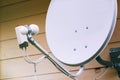 Satellite dish on the wall of a country house Royalty Free Stock Photo