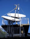 Satellite dishes, antennas on blue sky. Royalty Free Stock Photo