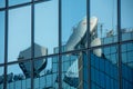 Satellite dishes reflected in the windows of a modern office building