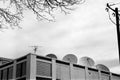 Satellite dishes surround the roof of a commercial building