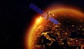 Satellite with a golden sunrise of the sun above the earth Royalty Free Stock Photo