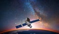 Satellite, hovering above the earth with view of sunrise Royalty Free Stock Photo