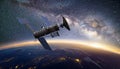 Satellite, hovering above the earth with view of sunrise Royalty Free Stock Photo