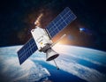 Satellite, hovering above the earth with view of sunrise Royalty Free Stock Photo