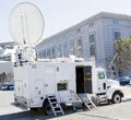Satellite news van parked near government building. Royalty Free Stock Photo