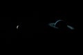 Satellite Oberon orbiting around Uranus planet in the outer space