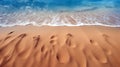 Satellite view of footprints in the sand of a beach near the ocean