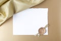 Satin on golden background with blank paper. Flat lay. Top view Royalty Free Stock Photo