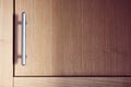 Satin nickel plated door handle on an alder wood cupboard or cabinet