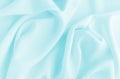 Satin silk fabric blue color for the background. Crumpled wavy silk. Texture of satin fabric Royalty Free Stock Photo