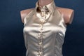 Satin and silk women shirt with mother-of-pearl buttons on a dark background. Style and fashion in clothes. Textile industry