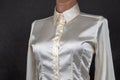 Satin and silk women shirt with mother-of-pearl buttons on a dark background. Style and fashion in clothes. Textile industry