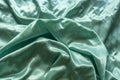 satin texture fabric with shiny light green waves as nice background Royalty Free Stock Photo