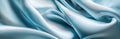 A satin texture in sky blue, featuring a gray-silver silk fabric background and a lovely, soft white natural pattern. Royalty Free Stock Photo