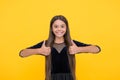 Satisfaction guaranteed. Happy child show thumbs ups yellow background. Satisfactory hand gesture. Satisfaction concept