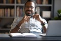 Satisfied African American businessman wearing headphones enjoying music Royalty Free Stock Photo