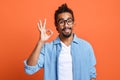 Satisfied african american man showing okay gesture with hand, demonstrating approvement