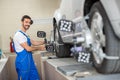 Satisfied auto mechanic working with sensor Royalty Free Stock Photo