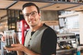 Satisfied barista keeping brew of tea