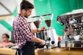 Satisfied barista steaming milk