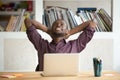 Satisfied African American leaning in chair happy with work res Royalty Free Stock Photo