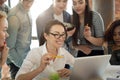 Smiling millennial professional team working together with laptop Royalty Free Stock Photo