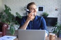 Satisfied business man in glasses holding smartphone near mouth for recording voice message or chatting online Royalty Free Stock Photo