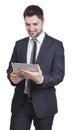 Satisfied businessman holding tablet