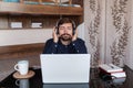 Satisfied businessman wearing headphones enjoying music at home Royalty Free Stock Photo