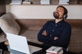 Satisfied businessman wearing headphones enjoying music at home Royalty Free Stock Photo