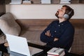 Satisfied businessman wearing headphones enjoying music at home Royalty Free Stock Photo