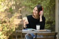 Satisfied caucasian woman listening to music on headphone and mobile phone at out door Royalty Free Stock Photo