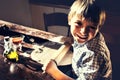 Satisfied child making homemade pizza