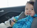 Satisfied child rides in a car seat. Happy baby ride in car. child safety