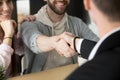 Satisfied couple handshaking realtor closing successful deal