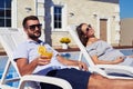 Satisfied couple relaxing in front of modern house with pool