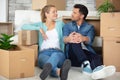 satisfied couple sat amongst cardboard boxes