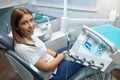 Dentistry, toothache.Satisfied patient a young girl in a dental chair waiting for a doctor, in a clinic box with medical Royalty Free Stock Photo