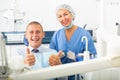 Satisfied patient visiting dentist giving thumbs up Royalty Free Stock Photo